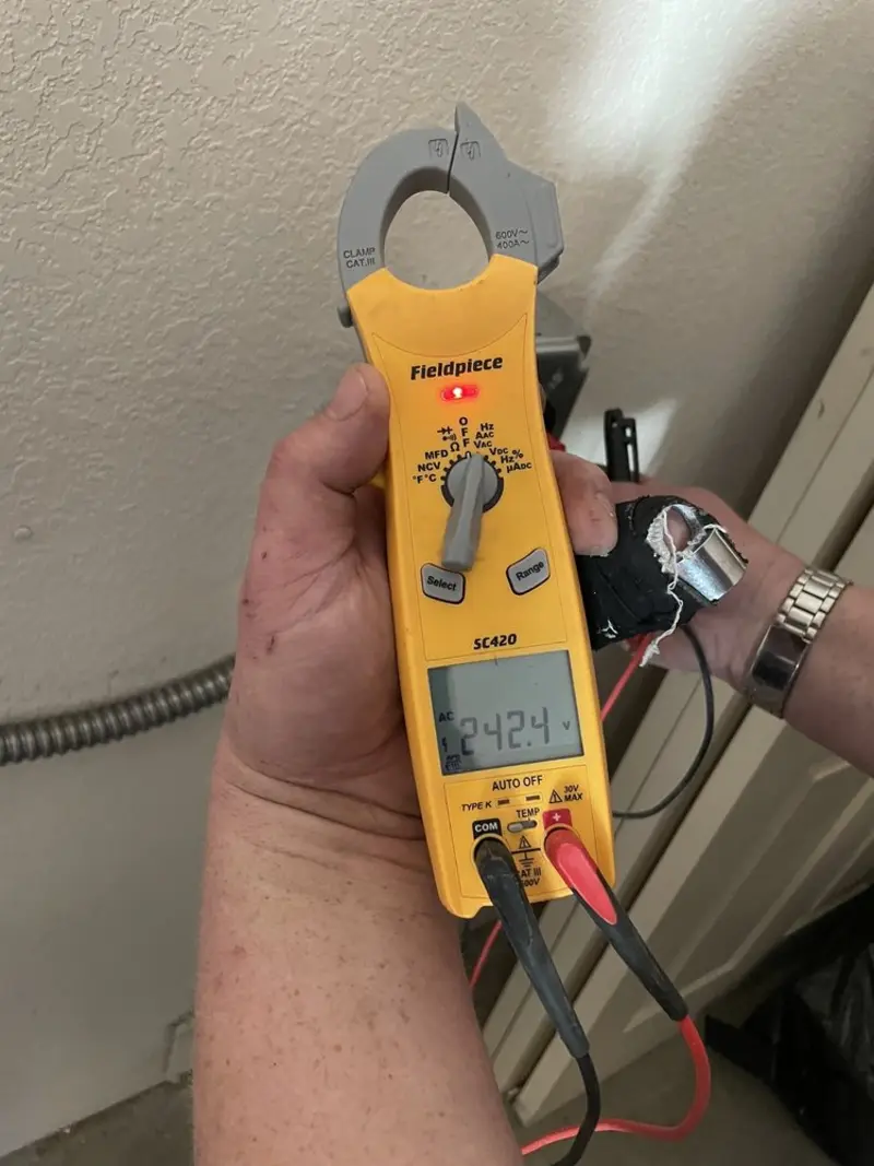 Voltage testing with clamp meter during Outlet Installation in Burnham